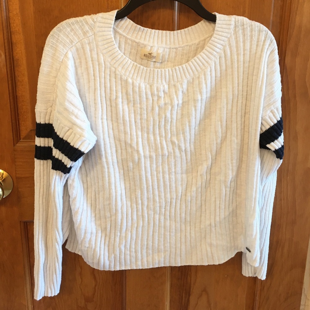 A white and navy blue sweater